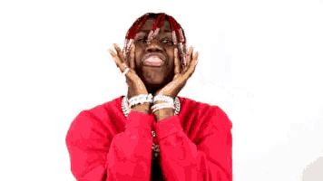 a man in a red sweater is covering his face with his hands and a thank you speech bubble above him