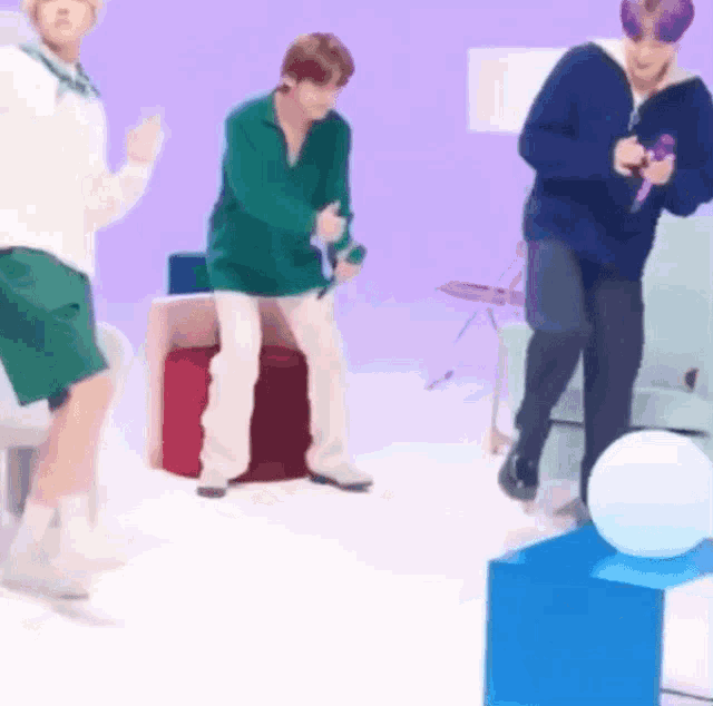 a group of people are dancing in a room while holding microphones .