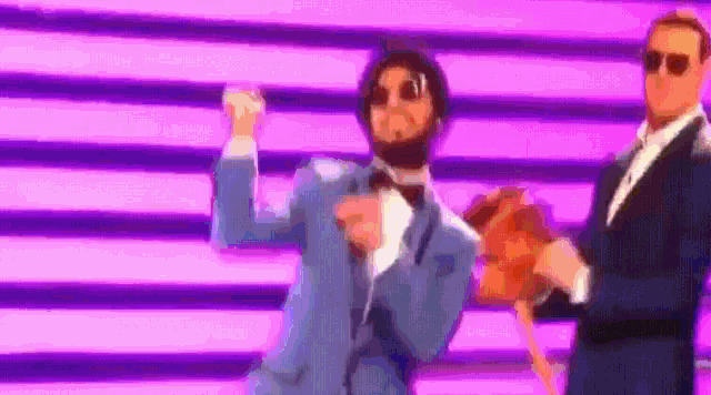 a man in a blue suit is dancing with another man in a black suit .