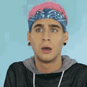 a man with pink hair and a blue bandana on his head