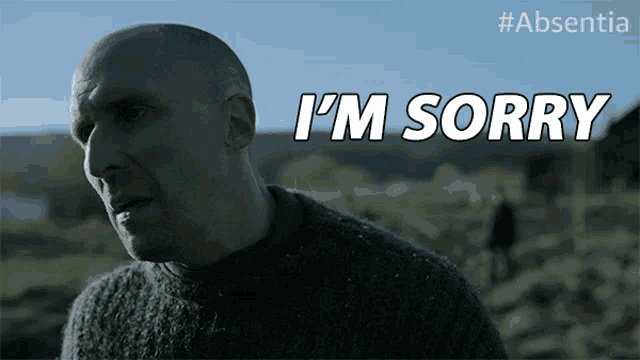 a man in a sweater says " i 'm sorry " in white letters