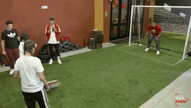 a group of people are playing soccer in a room that says black friday on it