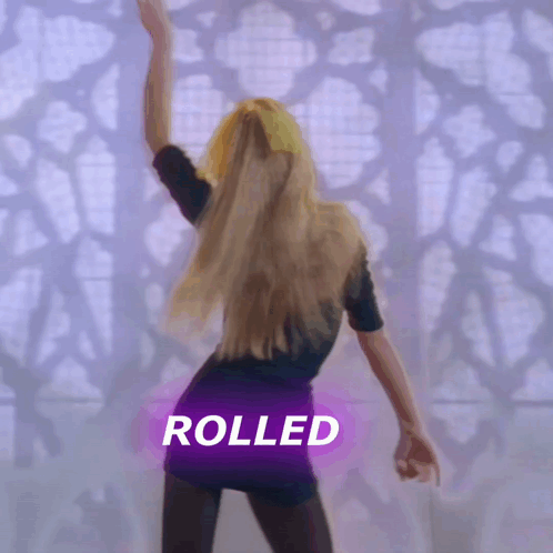 a woman is dancing in front of a purple sign that says rolled on it