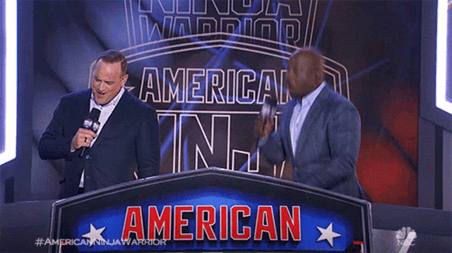 two men are standing in front of a sign that says american ninja