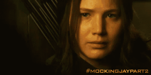 a close up of a woman 's face with the hashtag mockingjaypart2 on the bottom right