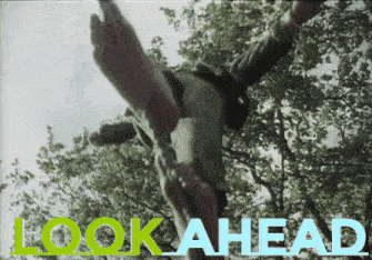 a sign that says look ahead with a person falling