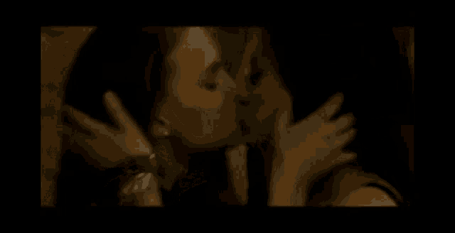 a man and a woman kissing in a dark room