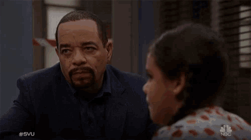 a man in a suit is talking to a little girl with the hashtag #svu on the bottom