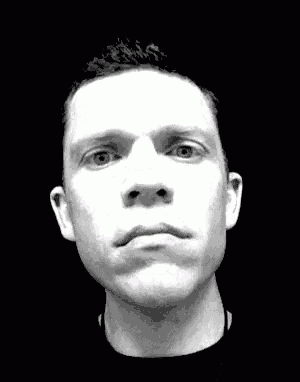 a man 's face is shown in a black and white photo with his eyes closed