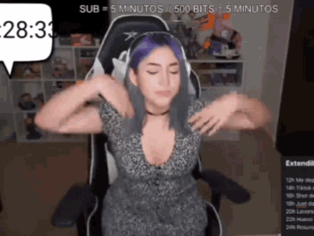 a woman with purple hair is sitting in a chair with her arms outstretched ..