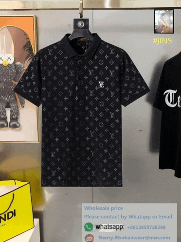 a black louis vuitton shirt is hanging on a hanger