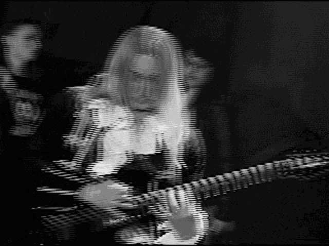 a blurry photo of a person playing a guitar