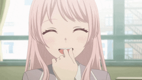 a girl with pink hair is smiling with her hand on her chin