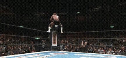 a man in a wrestling ring with a sign that says ' a ' on it