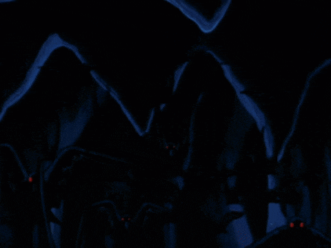 a bunch of bats with red eyes flying in the dark