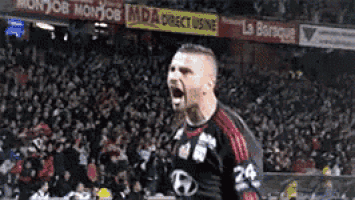 a soccer player with the number 24 on his jersey is celebrating