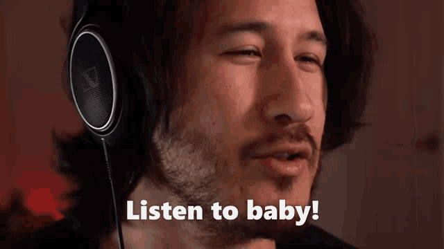 a man wearing headphones with the words listen to baby below him