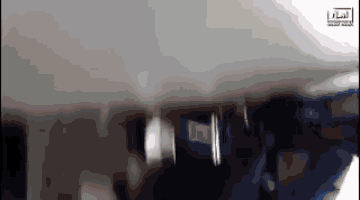 a blurry picture of a plane with arabic writing on the bottom