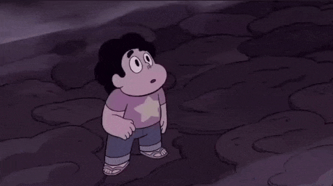 a cartoon character with a star on his shirt is standing on a rocky surface