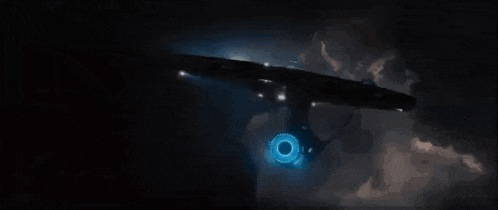 a space ship is flying through the air with a blue light coming out of it