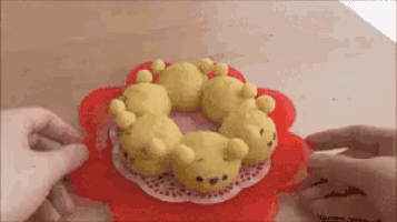a bunch of cookies shaped like teddy bears on a red flower