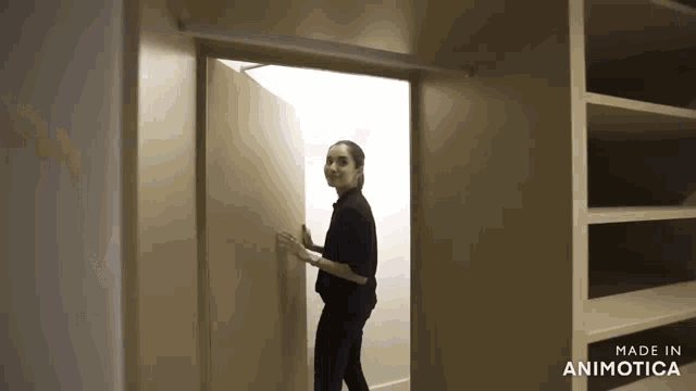 a woman opens a door in a closet made in animatica
