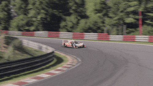 a race car is going around a curve on a race track