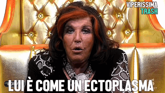 a woman with red hair is sitting in a chair with the words " lui e come un ectoplasma " below her