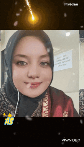 a woman wearing a hijab and ear buds is smiling in a mvideo
