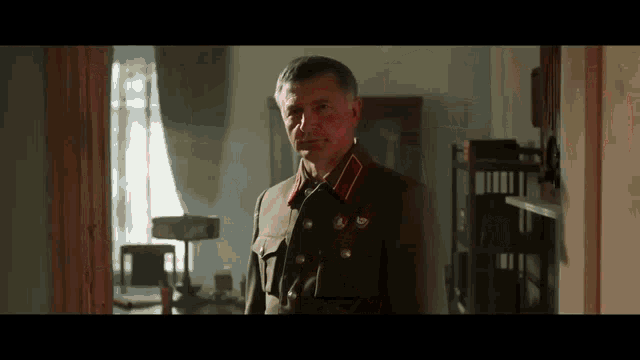 a man in a military uniform is standing in a room