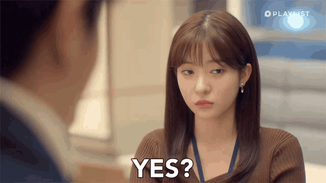 a woman is looking at a man and says " yes "