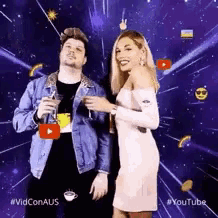 a man and a woman are standing next to each other in front of a youtube logo .