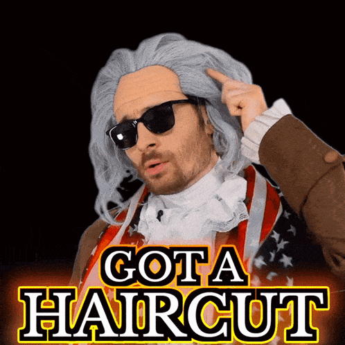 a man in a wig and sunglasses is pointing at his head with the words got a haircut above him