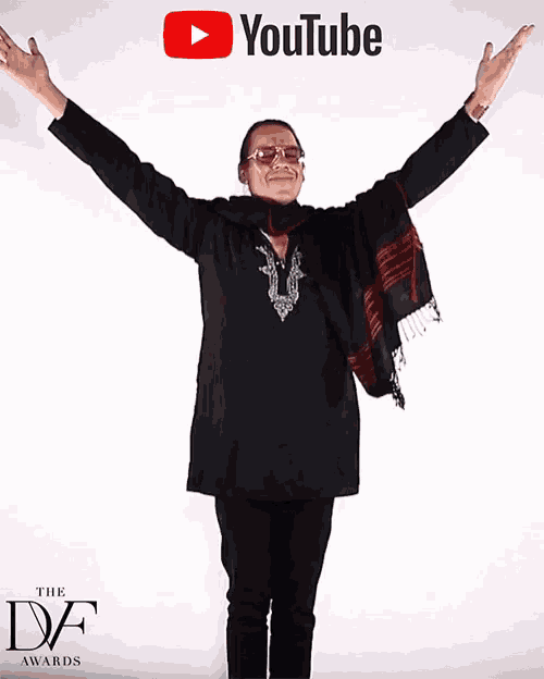 a man with his arms outstretched is standing in front of a youtube logo
