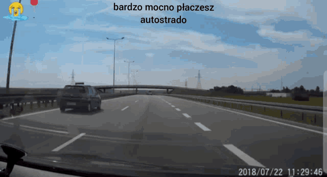 a car is driving down a highway with the words bardzo mocno placesz autostrado on the bottom