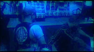 a blurry picture of a person standing in front of a bar