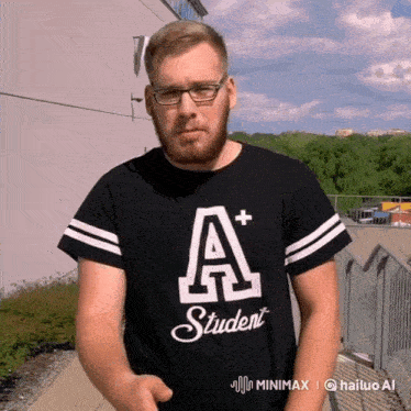 a man wearing a black shirt that says a+ student