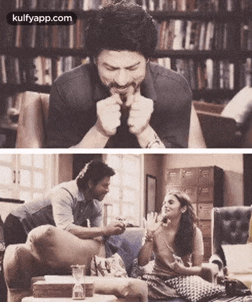 a man and a woman are sitting on a couch eating food .