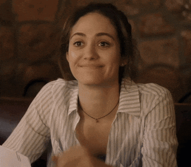 a woman wearing a striped shirt and a necklace with the letter s on it