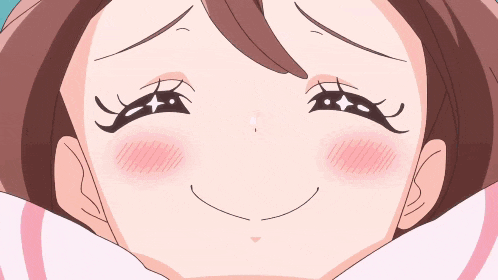 a close up of a girl 's face with a smile on her face