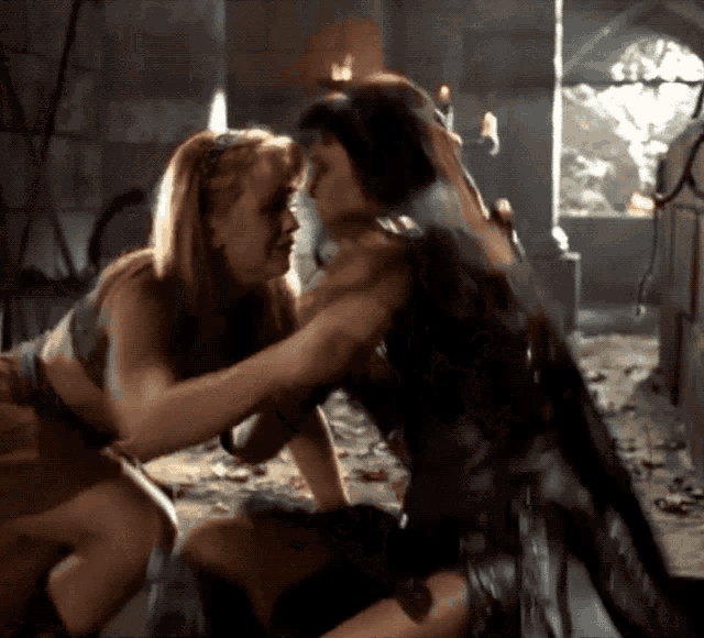 two women are hugging each other in a room