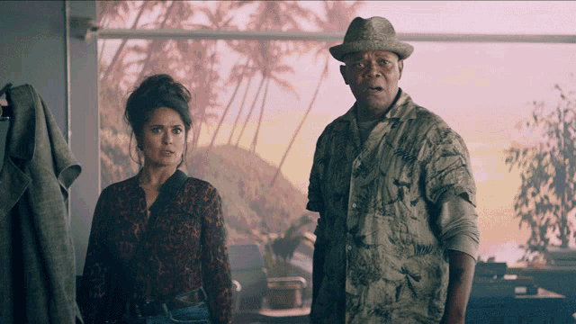 a man and a woman are standing next to each other in a room
