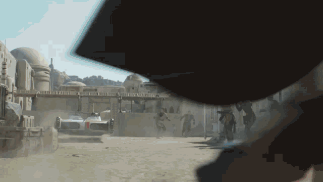 a blurred image of a desert scene with a car in the distance