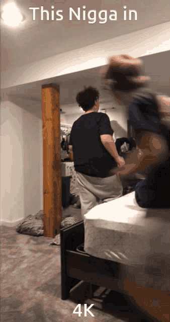 a blurry photo of a man jumping on a bed with the caption " this nigga in 4k "