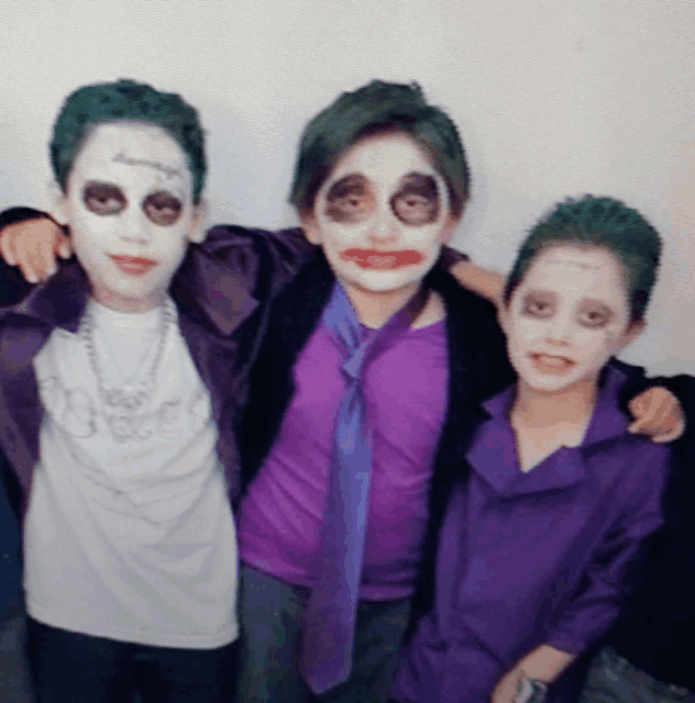three young boys dressed up as the joker and harley quinn