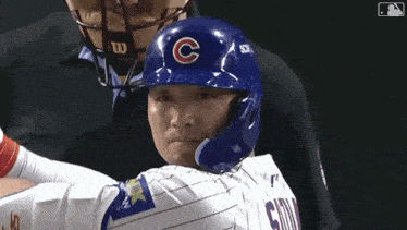 a baseball player wearing a helmet with a letter c on it