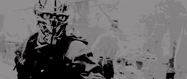 a black and white photo of a soldier in a helmet holding a gun .