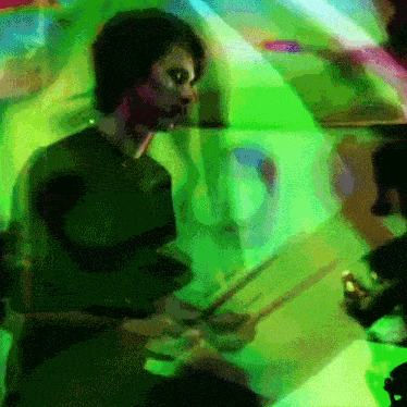 a blurry picture of a man playing a drum set