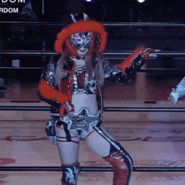 a female wrestler in a ring with the word rdom in the corner