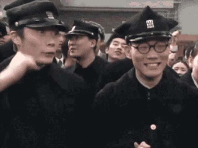 a man wearing a hat with the letter e on it is smiling